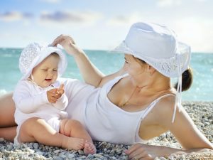mother and her baby on the beach