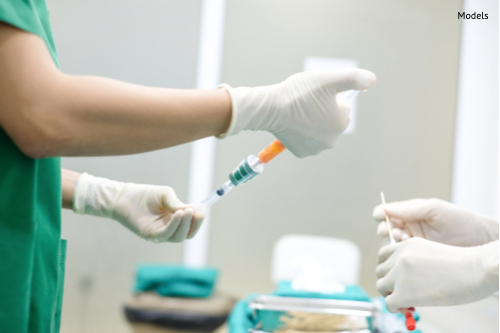 hands holding syringe and transfer fat with nano fat transfer tool in operation room-img-blog