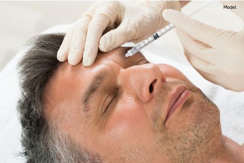 A man receives a cosmetic treatment injection. The stem cell facelift uses stem cell-enriched fat injections to boost facial volume, providing natural rejuvenation and refreshing the appearance.