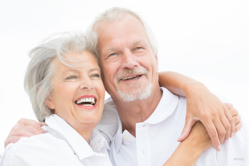 Happy and smiling couple in front of white sky